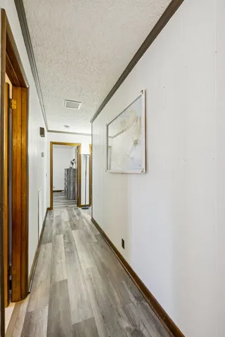 a view of a hallway with wooden floor