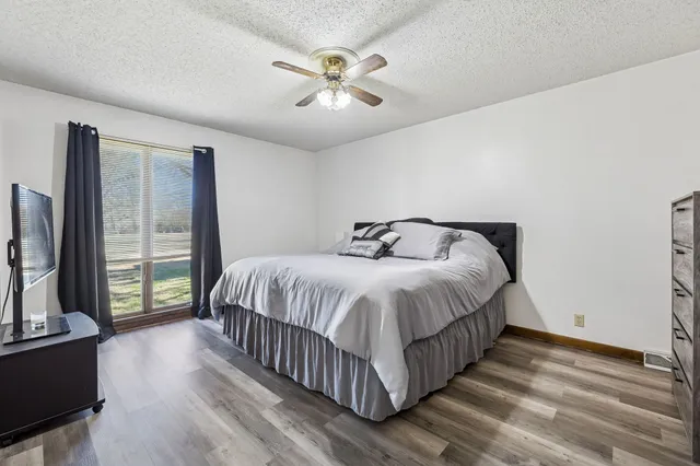 a bedroom with a large bed and a tv