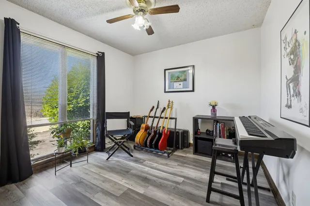 a view of a livingroom with furniture and gym equipment