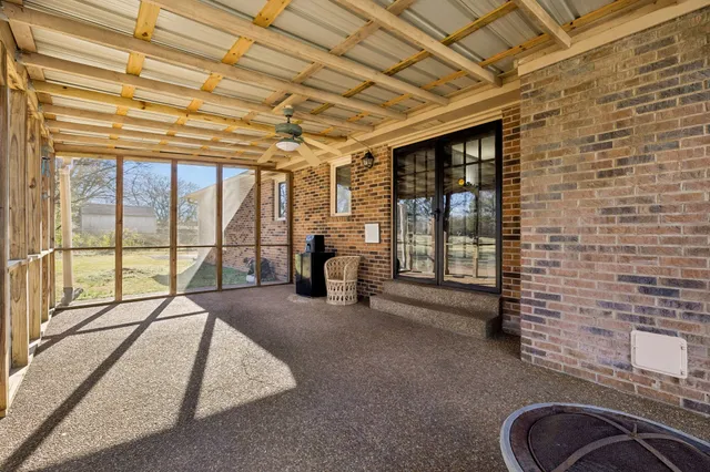 a view of living room with furniture and large windows