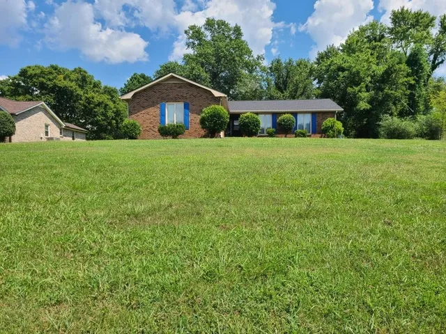 a front view of house with yard and green space