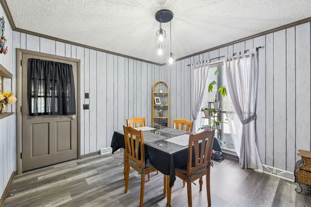 a view of a dining room with furniture window and wooden floor