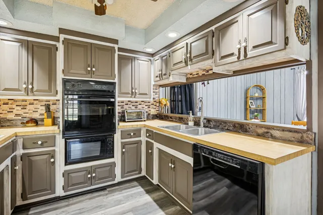 a kitchen with a sink stove and cabinets