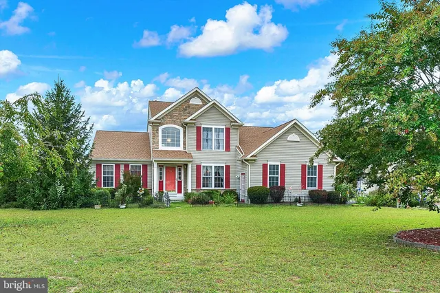 a front view of a house with a garden and plants