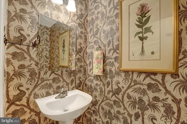 a bathroom with a sink and mirror with toilet