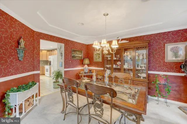 a view of a dining room with furniture and chandelier