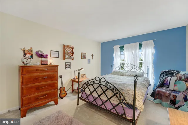 a bedroom with a bed and a dresser in it
