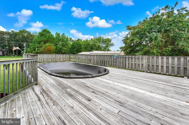 a view of balcony with wooden floor and fence