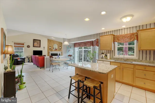 a living room with furniture a flat screen tv and large windows
