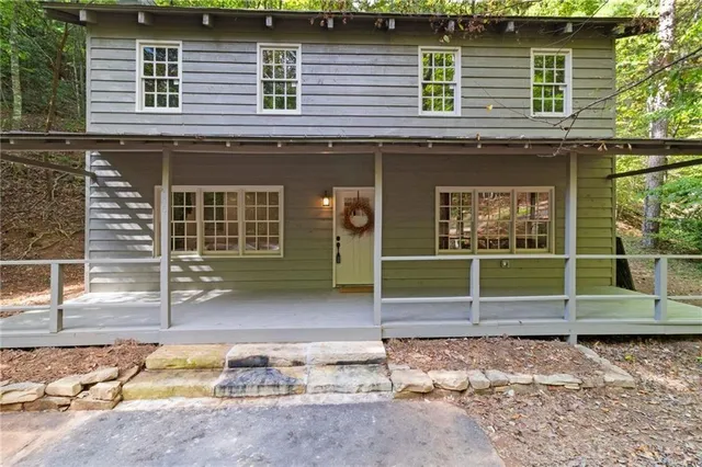 a view of a house with wooden fence