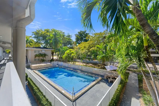 a view of a patio with a table and chairs and potted plants