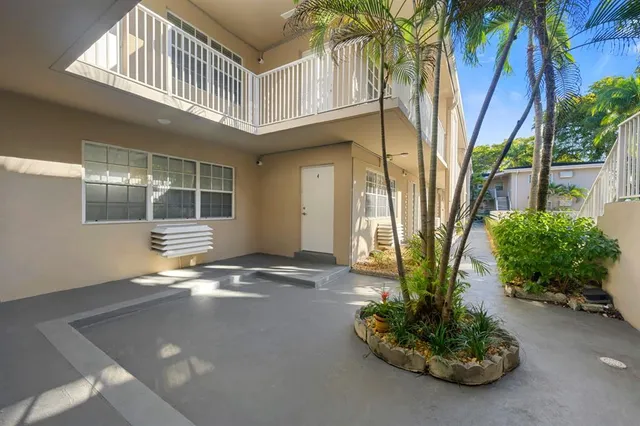 a view of an entryway with a flower pot and a yard
