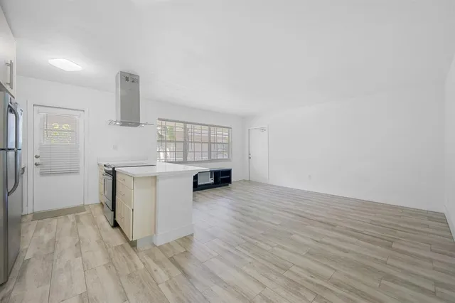 a view of kitchen with furniture and wooden floor