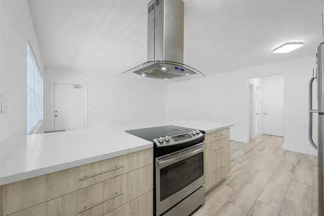 a kitchen with granite countertop a stove and a refrigerator