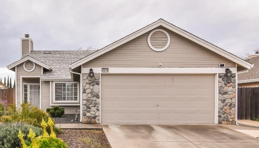 a front view of a house with a parking area