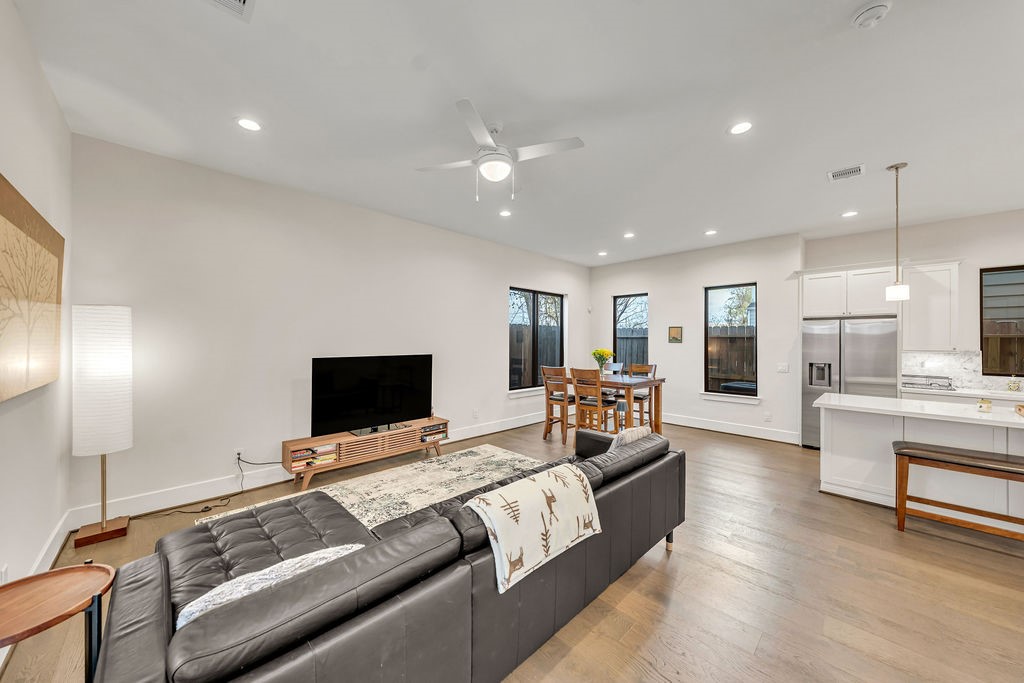 3510 Huntsford Drive Houston, TX 77008 - Photo 11 of 34 a living room with furniture flat screen tv and refrigerator