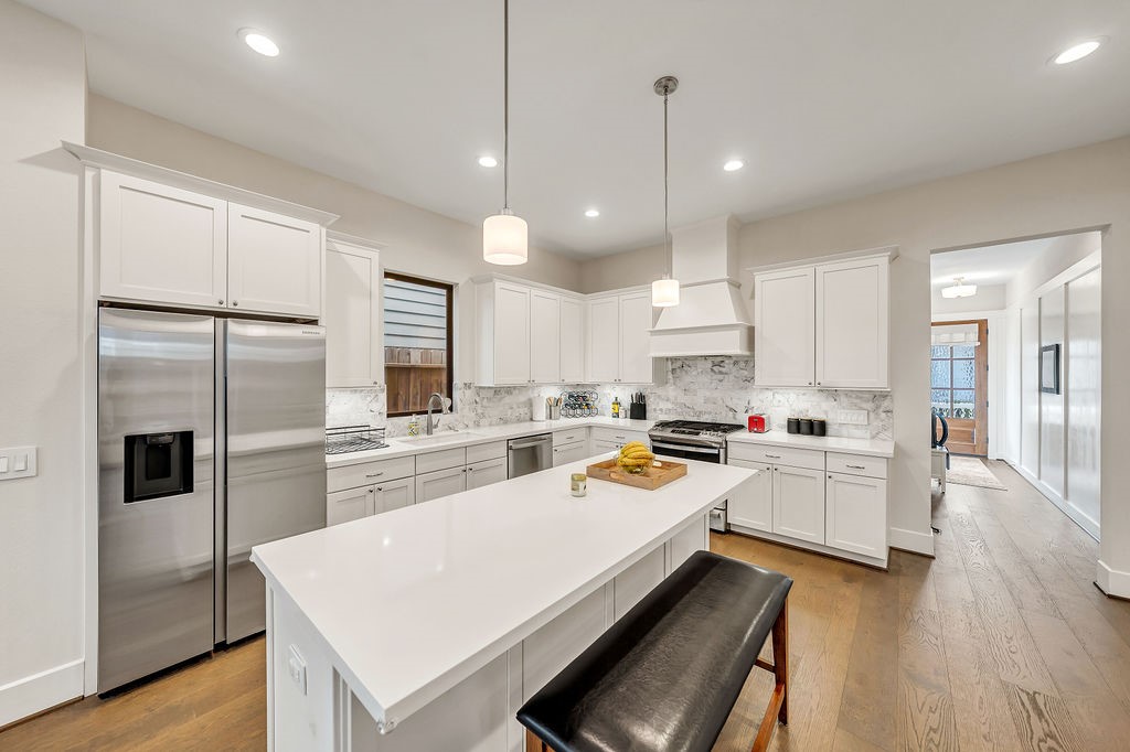 3510 Huntsford Drive Houston, TX 77008 - Photo 2 of 34 a large kitchen with a refrigerator a stove a sink dishwasher a oven with white cabinets and wooden floor