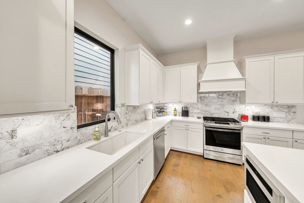 3510 Huntsford Drive Houston, TX 77008 - Photo 7 of 34 a kitchen with a sink a stove and cabinets