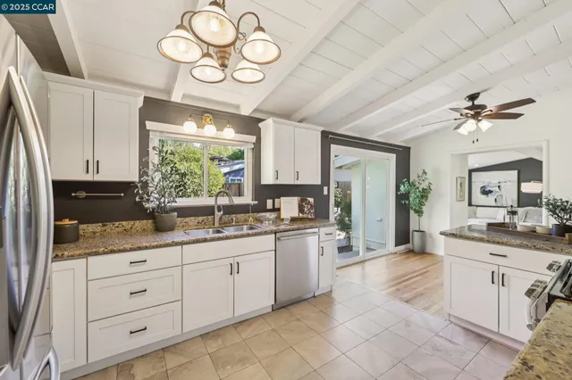 a large kitchen with a large window appliances and cabinets