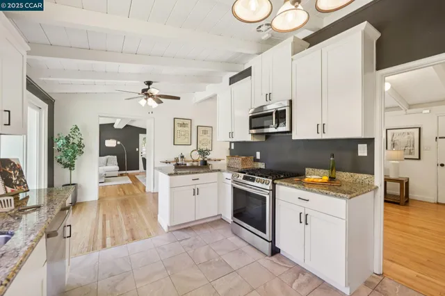 a kitchen with a stove a sink and a refrigerator