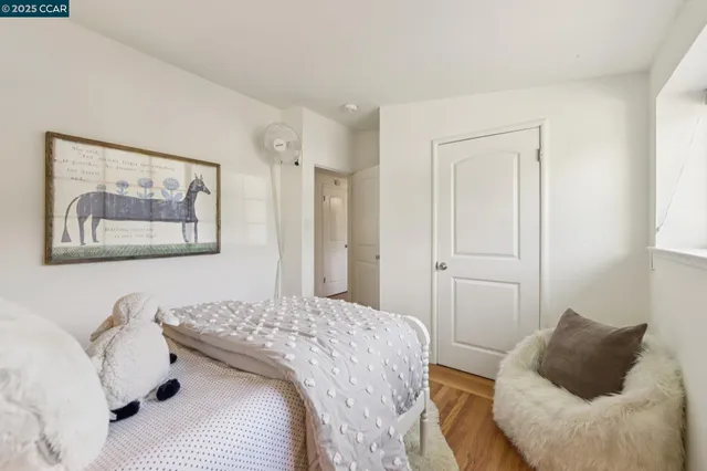 a bedroom with a bed and a painting on the wall