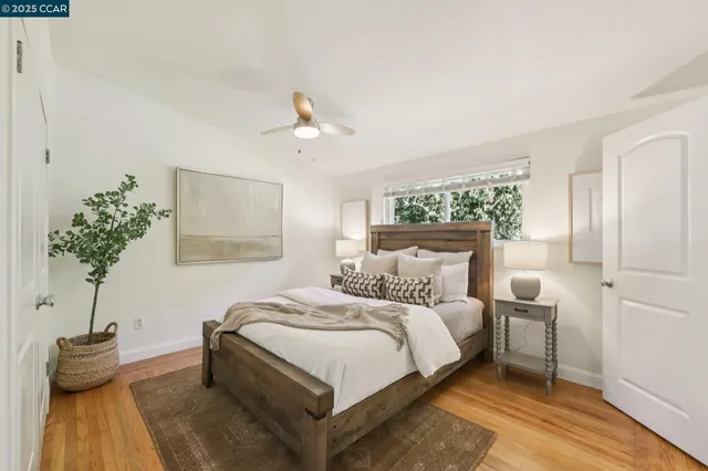 a bedroom with a bed and a potted plant