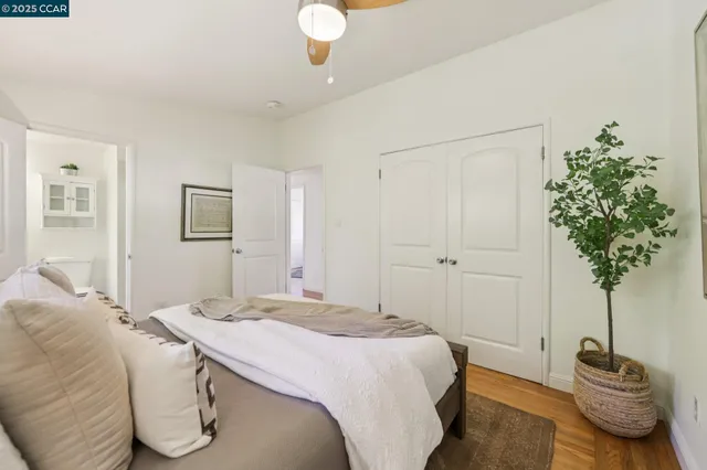 a bedroom with a bed and a potted plant