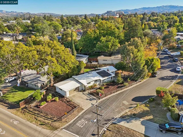 an aerial view of a house with a yard