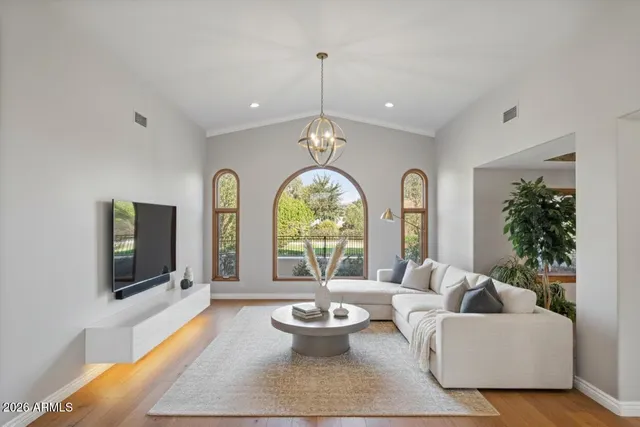 a kitchen with a refrigerator a sink and wooden floor