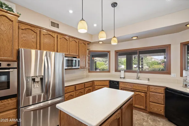 a spacious bathroom with a granite countertop sink a mirror and shower