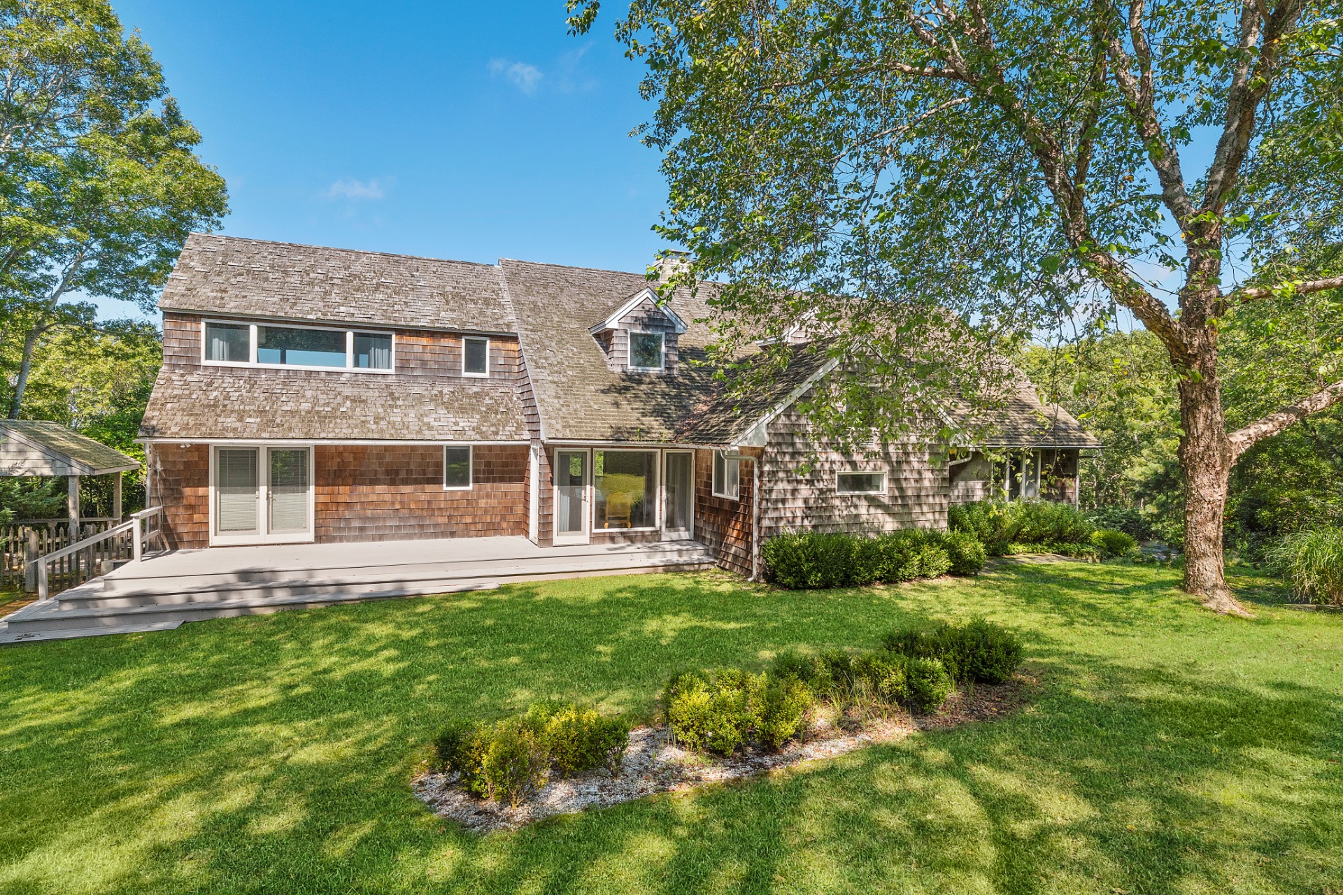 28 Deer Ridge Trail Water Mill, NY 11976 - Photo 18 of 23 front view of a brick house with a yard