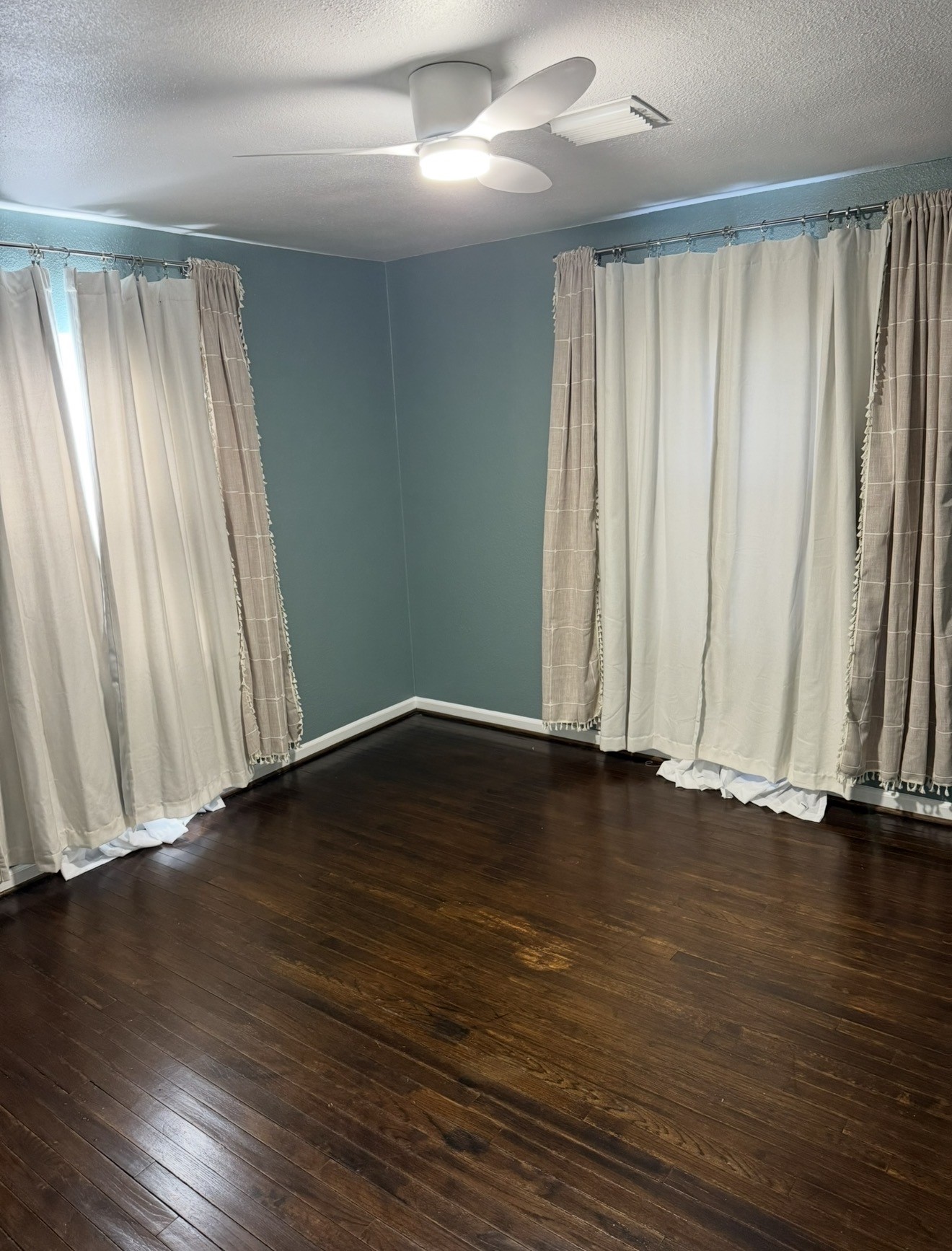1406 Kirwin Street Galveston, TX 77551 - Photo 11 of 13 an empty room with wooden floor and sliding window