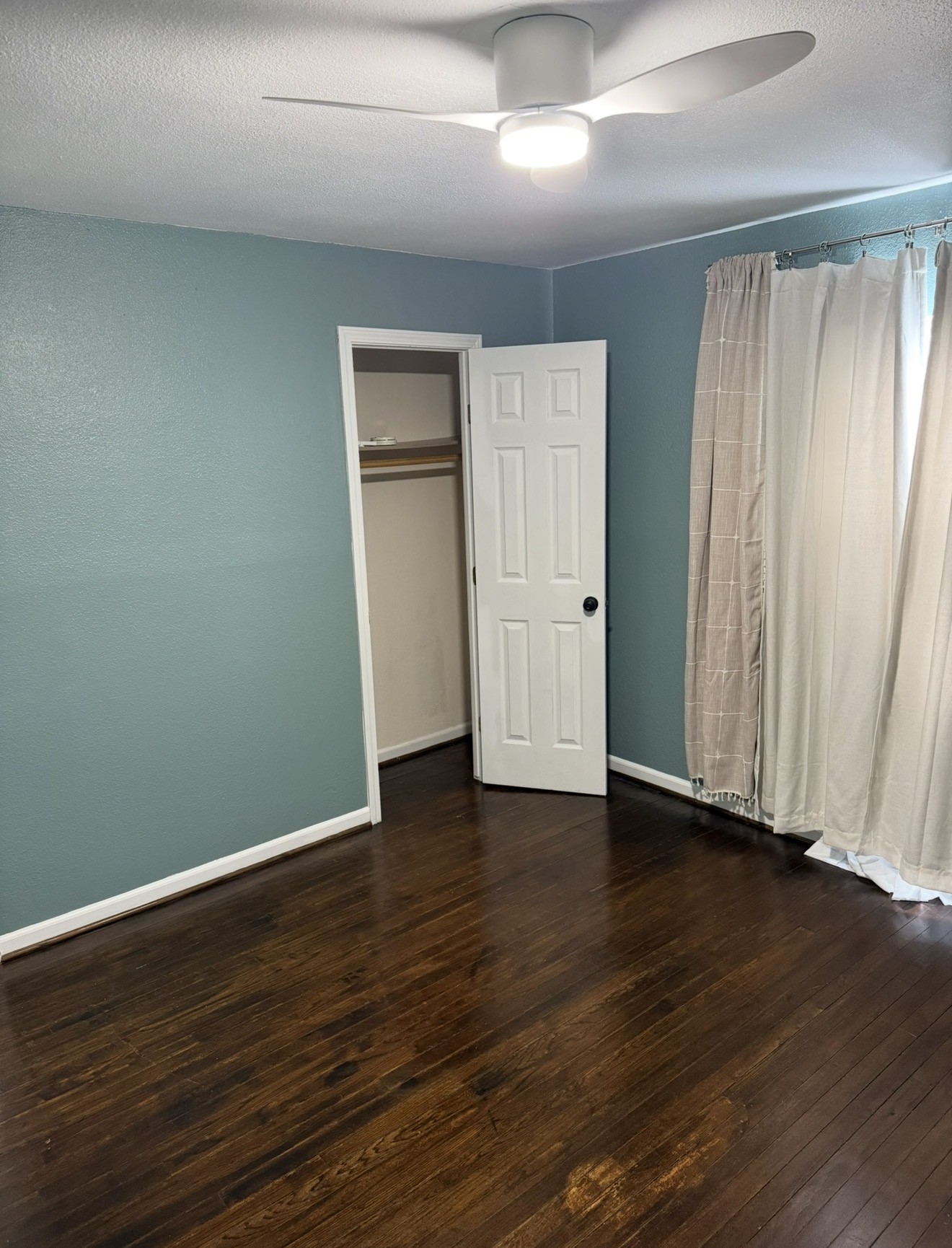 1406 Kirwin Street Galveston, TX 77551 - Photo 12 of 13 an empty room with wooden floor and windows