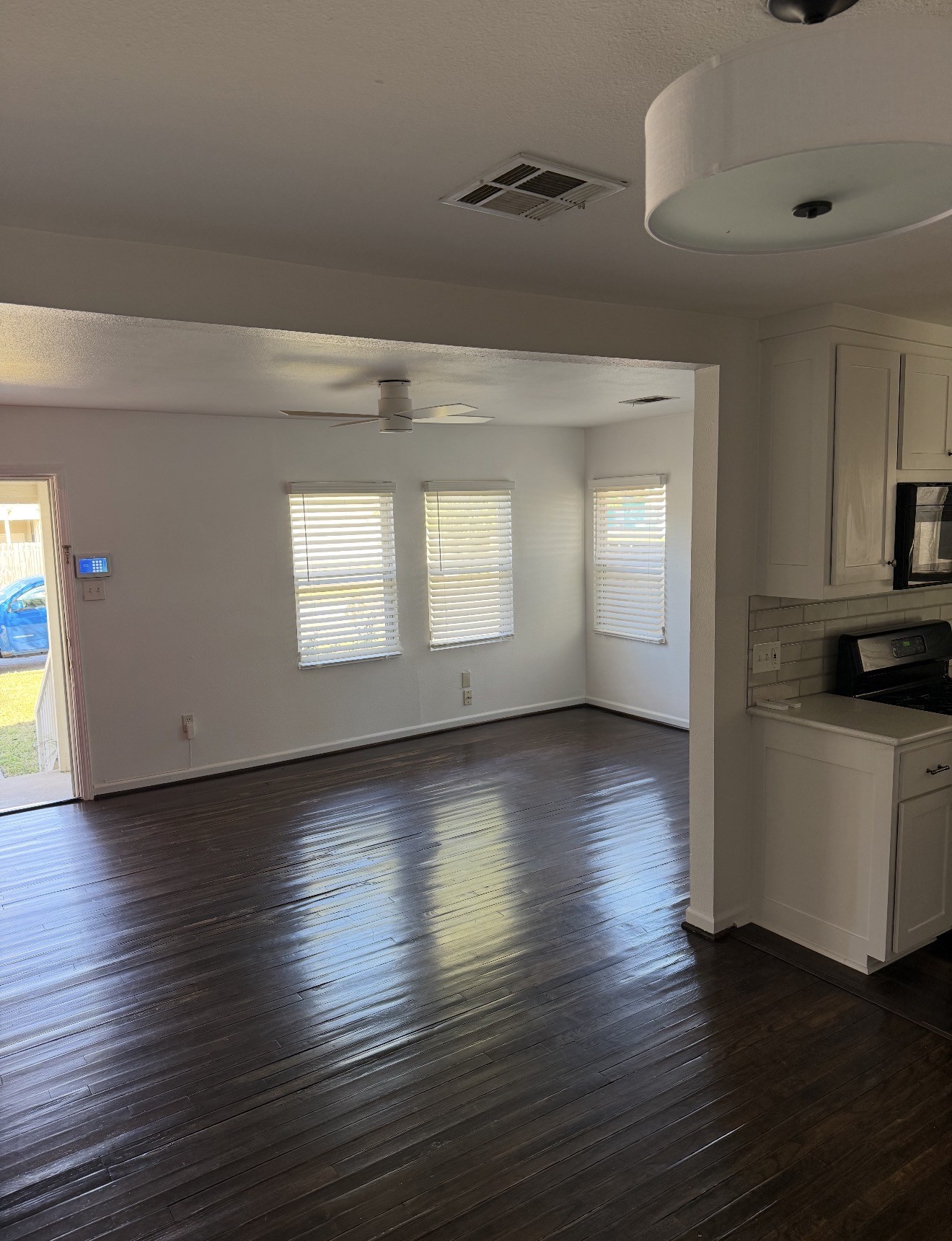 1406 Kirwin Street Galveston, TX 77551 - Photo 4 of 13 a view of a room with wooden floors and fireplace