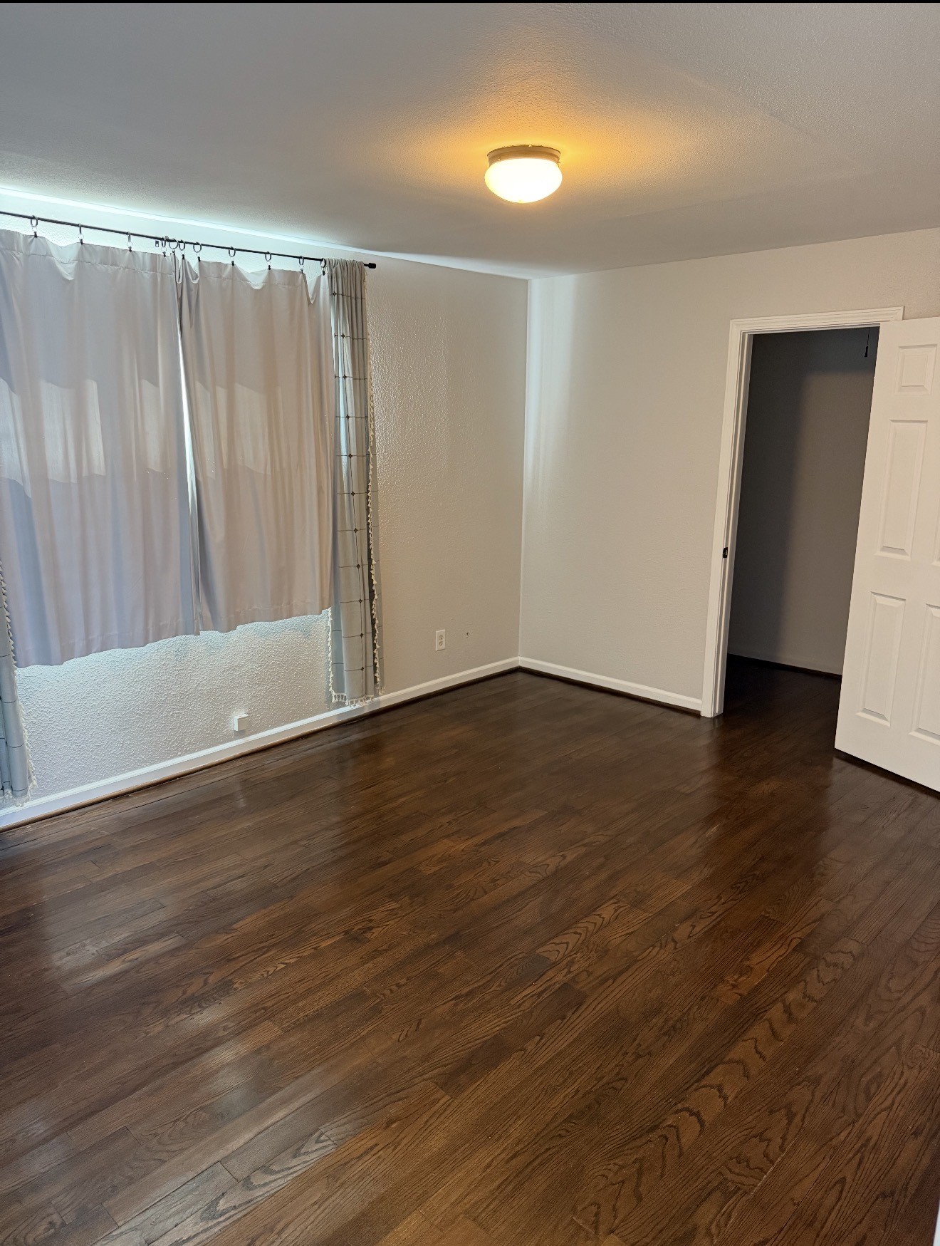 1406 Kirwin Street Galveston, TX 77551 - Photo 8 of 13 a view of an empty room with wooden floor and a window