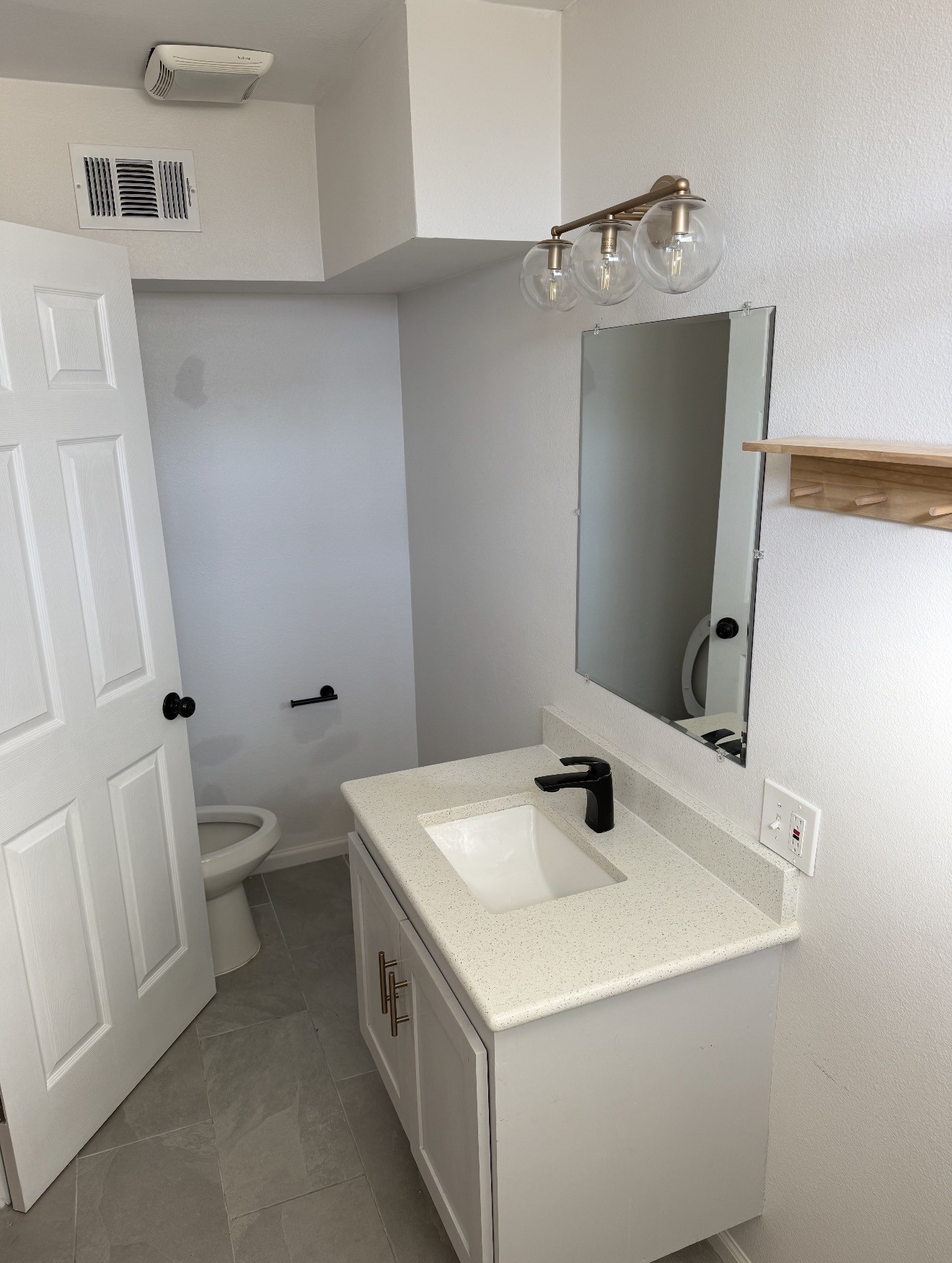 1406 Kirwin Street Galveston, TX 77551 - Photo 10 of 13 a bathroom with a sink and a mirror
