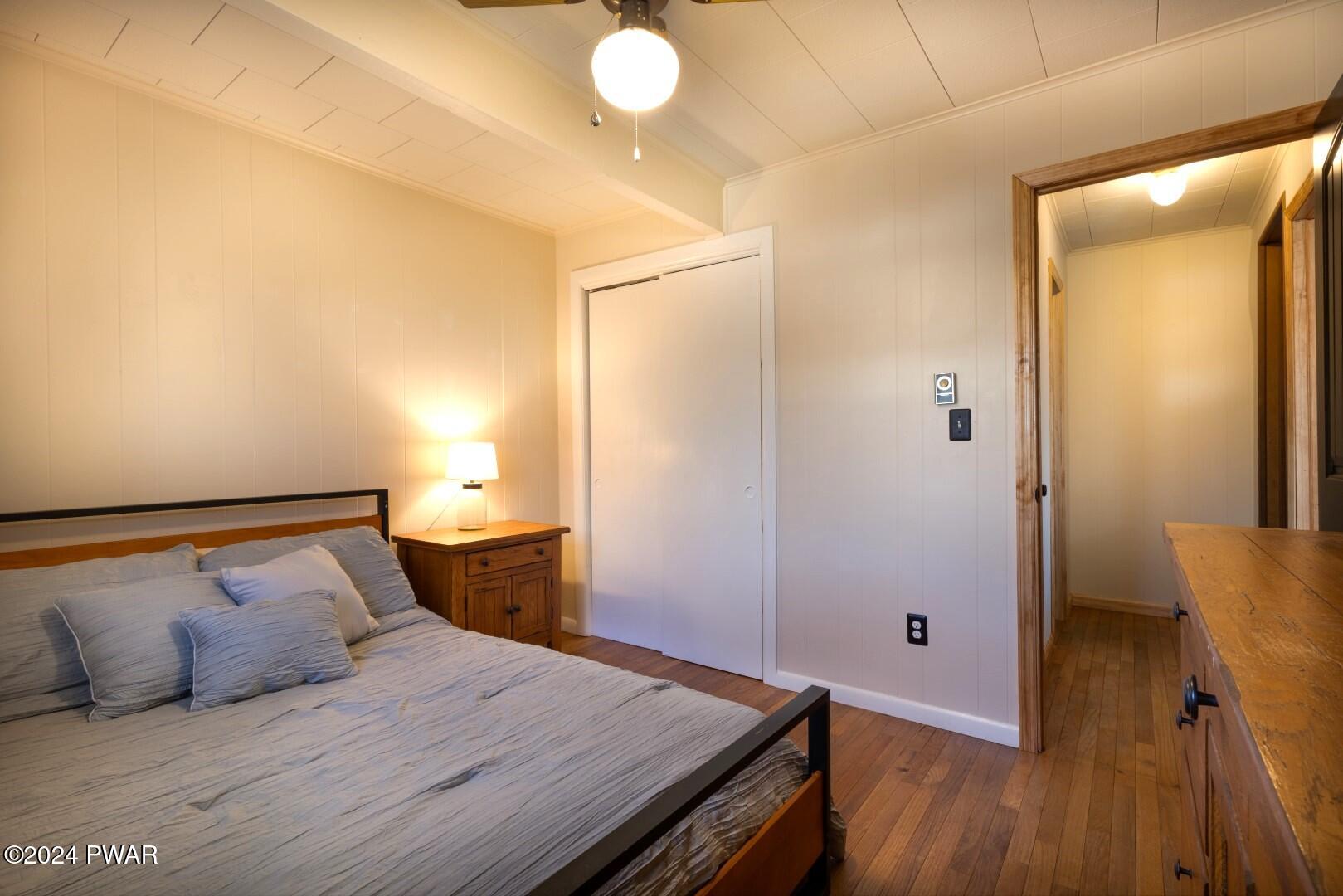 137 Stonehenge Road Milford, PA 18337 - Photo 14 of 30 a bedroom with a bed and wooden floor