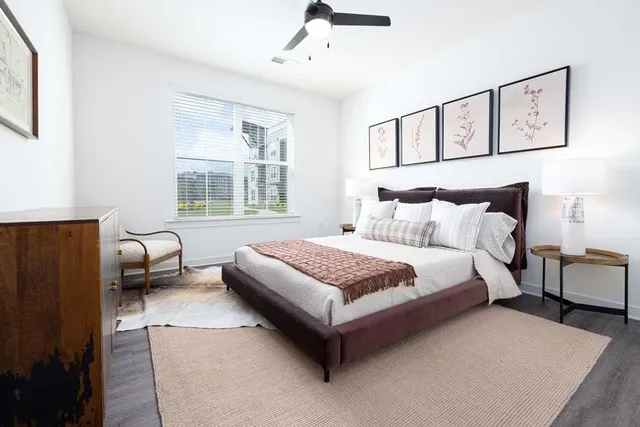 a bedroom with a bed couch and window