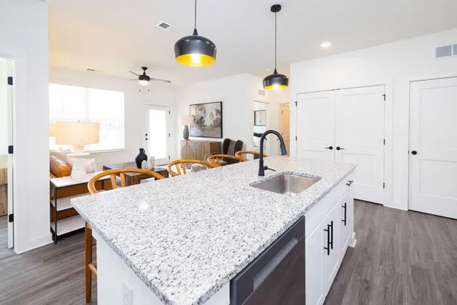 a kitchen with granite countertop sink and chandelier