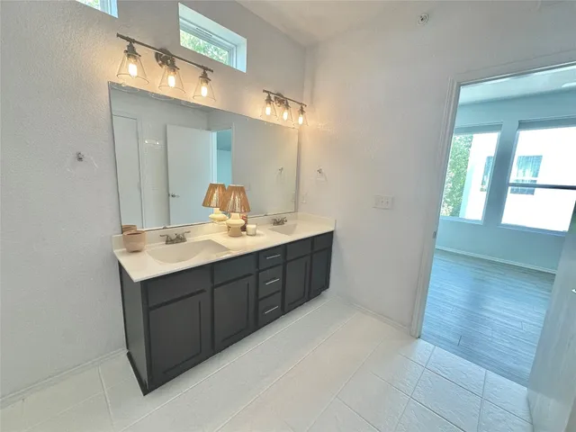 a bathroom with a sink vanity granite and a mirror