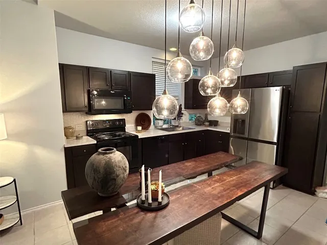 a kitchen with a table and chairs