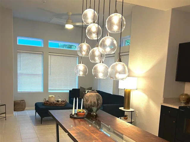 a view of a room with a chandelier furniture and windows