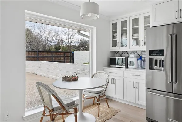 a kitchen with stainless steel appliances granite countertop a dining table and chairs