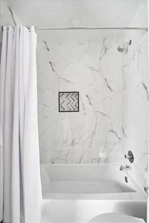a bathroom with a bathtub and shower
