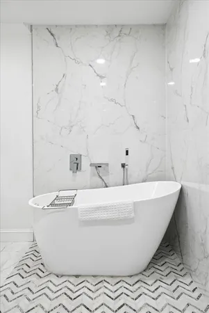 a white bath tub sitting in a bathroom