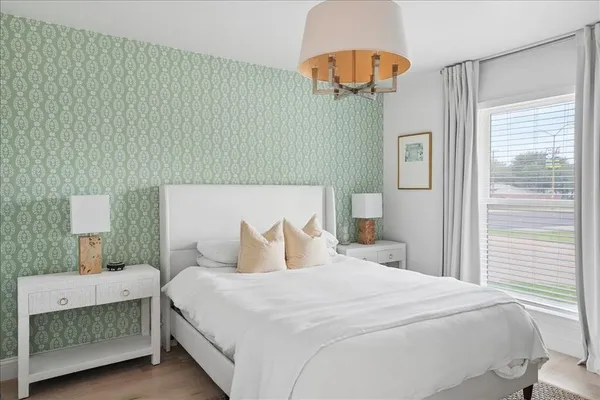 a bedroom with a bed and a chandelier