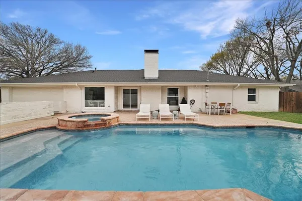 a swimming pool with outdoor seating and yard