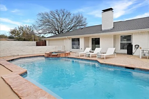 a view of a house with a backyard porch and sitting area