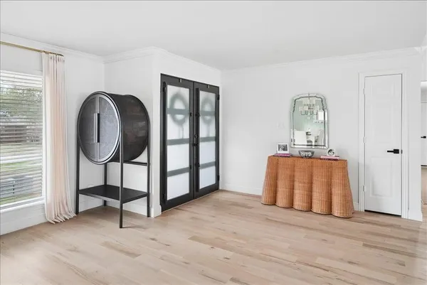 a view of a room with wooden floor and window