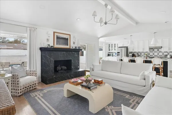 a living room with furniture a fireplace and a table